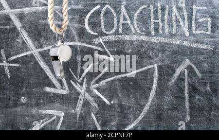 coaching symbol or concept,qualification, further education concept, whistle of a soccer referee on black board Stock Photo