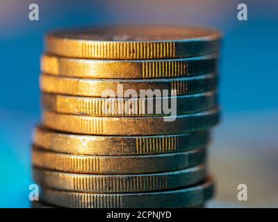 Close up view on euro coin stack on blue background. Stock Photo
