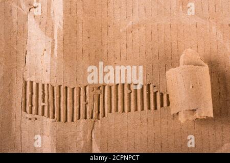 Top view of torn edges corrugated brown cardboard sheet of paper texture or background flat lay, Folded recycle carton paper box Stock Photo