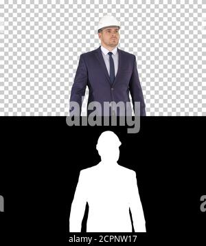 Construction worker in a suit putting on helmet Safety concept, Stock Photo