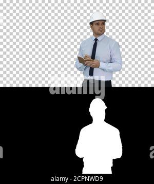 Man in helmet and formal clothes walking looking around and maki Stock Photo