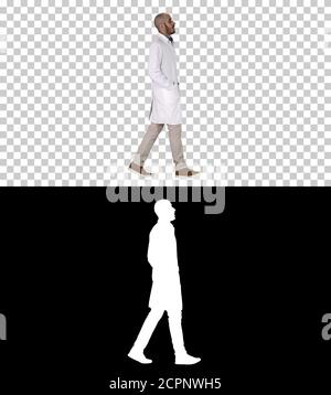 Doctor walking with hands in pockets, Alpha Channel Stock Photo