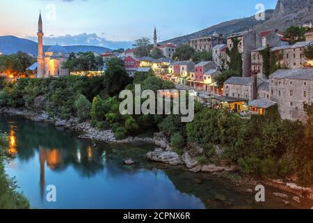 Sunset over the Neretva river banks of the city of Mostar in Bosnia Herzegovina seen from the Stari Most Bridge (Old Bridge). Stock Photo