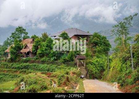 Small rural house on the side of rice paddies along Sapa dirt road in Northern Vietnam. October 2019 Stock Photo