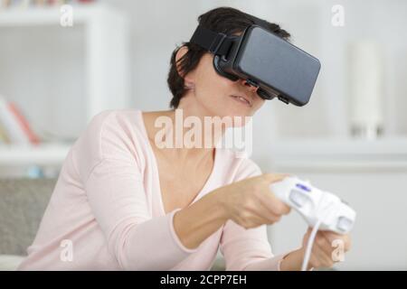 mature female student using virtual reality headset Stock Photo