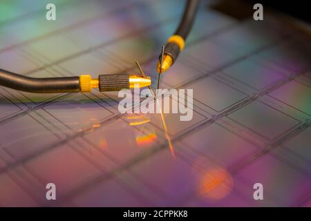 Manual probe system with needles for test of semiconductor on silicon wafer. Selective focus. Stock Photo
