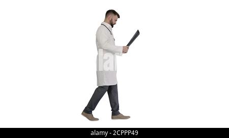 Medical doctor walking and looking at x-ray picture of lungs on Stock Photo
