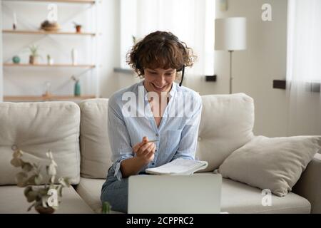 Smiling Caucasian woman study online on laptop Stock Photo
