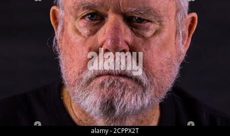 Close Up Of Senior Man Staring Into Camera Stock Photo