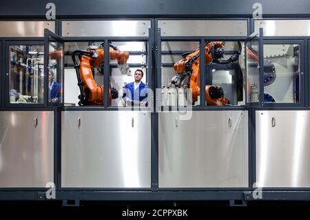 Dortmund, North Rhine-Westphalia, Germany - high technology in the Ruhr area. A technician from carat robotic innovation GmbH programs an articulated Stock Photo