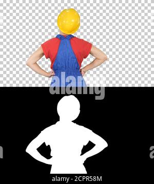 Female construction worker with hands on hips looking at somethi Stock Photo