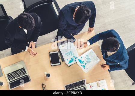 Group business people handshake at meeting table in office together with confident shot from top view . Young businessman and businesswoman workers Stock Photo
