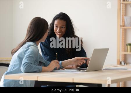Smiling diverse colleagues working on online project together Stock Photo