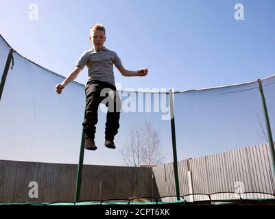 Boy jumping on a trampoline. Jumping on a trampoline. Stock Photo