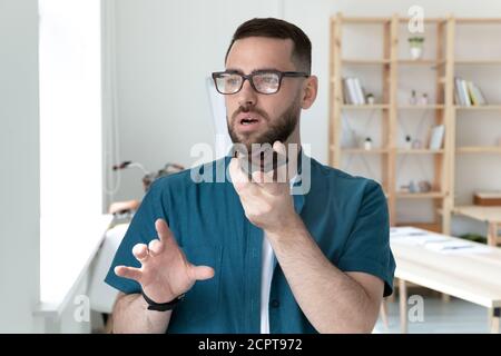 Close up confident young businessman recording voice message, using smartphone Stock Photo