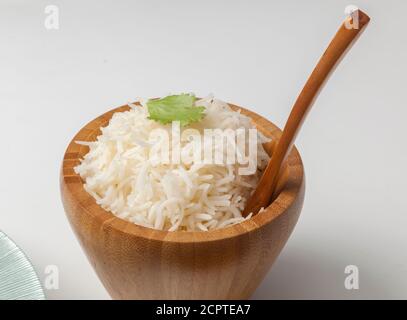Basmati rice in a wooden bowl with spoon Stock Photo