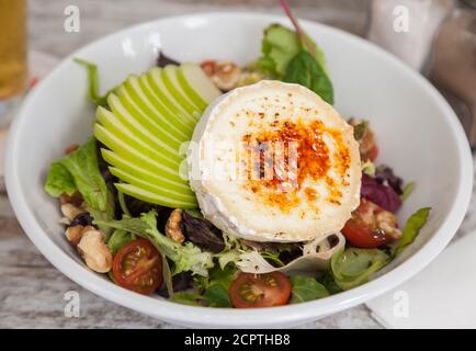 Healthy salad with fresh apple and goat cheese Stock Photo