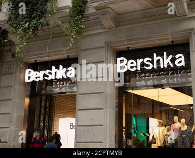 BARCELONA, SPAIN - NOVEMBER 23, 2019: Tourists enjoy shopping at the Bershka store in Barcelona. Stock Photo