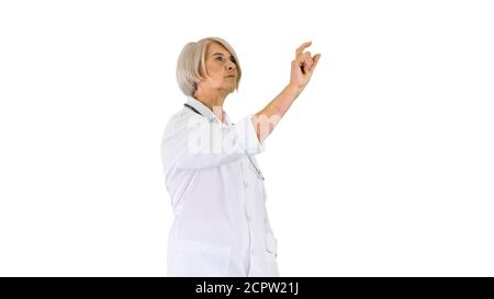 Elder female doctor pressing a buttons on imaginary futuristic s Stock Photo
