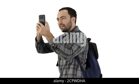 Attractive young tourist with backpack walking and using mobile Stock Photo