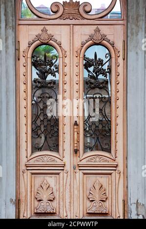 Wooden doors with floral iron cast decoration Stock Photo