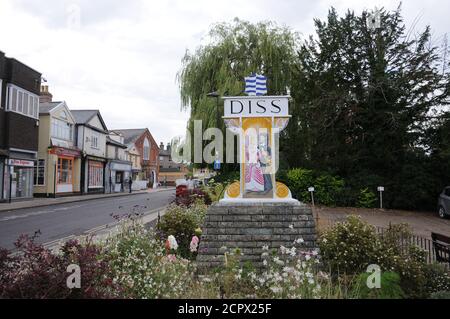 Town Sign , Diss, Norfolk. This side depicts Matilda, the daughter of the Lord of the Manor of Diss being presented with a poisoned boiled egg. Stock Photo