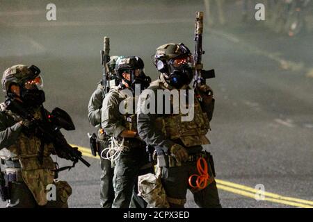 Portland, USA. 18th Sep, 2020. ICE and Border Patrol SWAT teams armed wih assault rifles charge demonstrators. Demonstrators clashed with Federal and Portland police and an unlawful assembly was declared in the fourth month of protests, after protesters attacked an ICE (Immigration and Customs Enforcement) building in downtown Portland, Oregon, on September 18, 2020. (Photo by John Rudoff/Sipa USA) Credit: Sipa USA/Alamy Live News Stock Photo