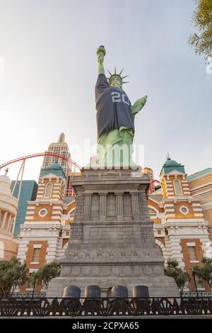 Las Vegas, SEP 15, 2020 - Afternoon sunny view of the Statue of Liberty wear Raiders football shirt and face mask Stock Photo