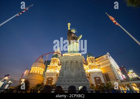 Las Vegas, SEP 15, 2020 - Night view of the Statue of Liberty wear Raiders football shirt and face mask with The New York New York casino Stock Photo