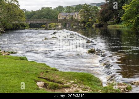 Weir on the River Wharfe above Linton Falls, Grassington, after a rain shower. There are two weirs, this is the lower. Wharfedale in the Yorks Dales Stock Photo