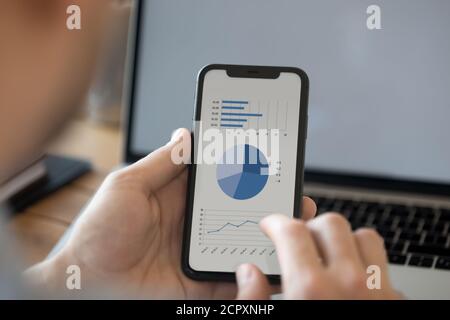 Close up of man using modern cellphone analyzing finances Stock Photo