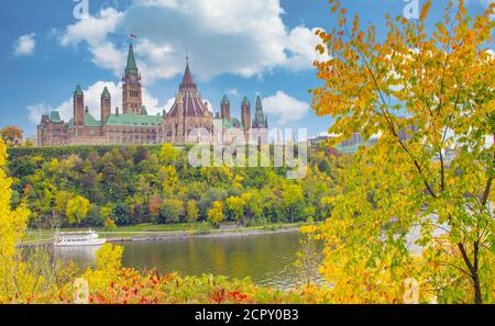 Parliament Hill with brilliant autumn foliage and reflections on Ottawa River in Ontario, Canada Stock Photo