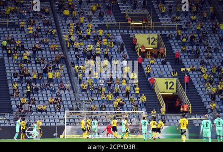 Dortmund, Germany. 19th Sep, 2020. Football: Bundesliga, Borussia Dortmund - Borussia Mönchengladbach, 1st matchday at Signal Iduna Park. Spectators in the stands follow the match. IMPORTANT NOTICE: In accordance with the regulations of the DFL Deutsche Fußball Liga and the DFB Deutscher Fußball-Bund, it is prohibited to use or have used in the stadium and/or photographs taken of the match in the form of sequence images and/or video-like photo series. Credit: Bernd Thissen/dpa/Alamy Live News Stock Photo