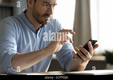 Close up of man using smartphone texting Stock Photo