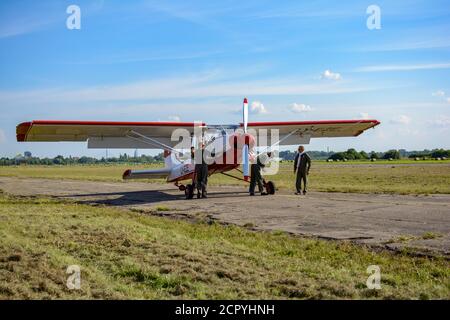 Cabin crew near its Aero L-60 Brigadýr standing on take-off strip Stock Photo