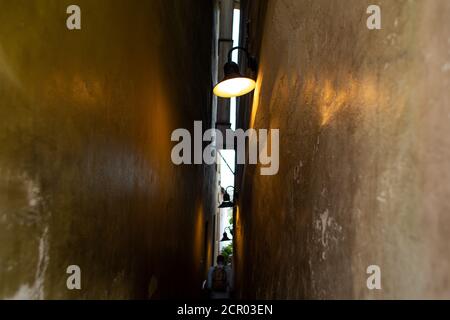 The architecture of the strago city of Prague. The narrowest street in Europe. The passage between buildings for one person, regulated by traffic ligh Stock Photo