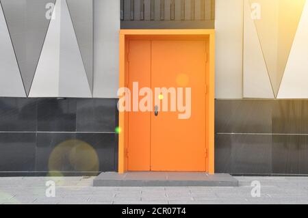 closed metal fire door in orange color. Stock Photo