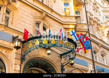 The facade of the old diplomatic building is decorated with flags of different countries. Stock Photo