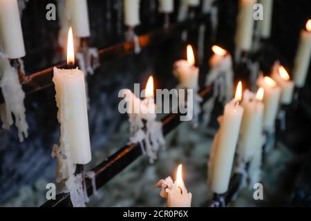 Sacrificial candles burn in front of the candle chapel, Kevelaer, Niederrhein, North Rhine-Westphalia, Germany Stock Photo