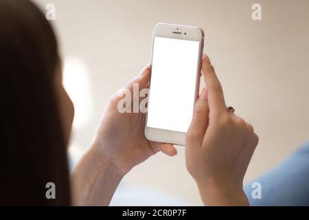 Woman using modern cell phone with blank white screen Stock Photo