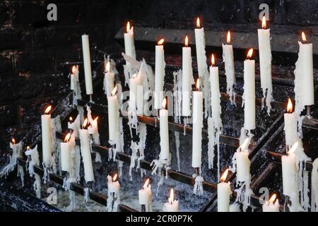 Sacrificial candles burn in front of the candle chapel, Kevelaer, Niederrhein, North Rhine-Westphalia, Germany Stock Photo