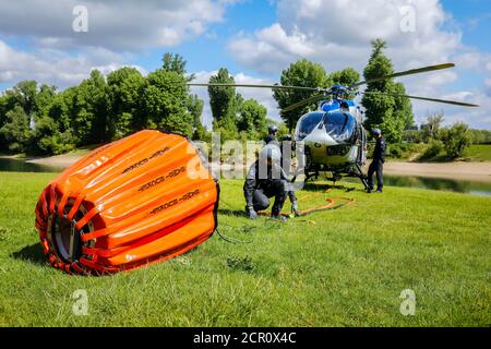 Airbus H 145 police helicopter during an operational exercise with the BAMBI BUCKET extinguishing water tank, Düsseldorf, North Rhine-Westphalia, Stock Photo