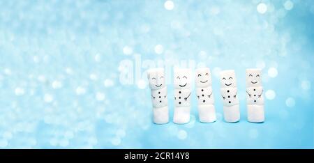 Snowmen on a blue background with bokeh effect. Banner for the website header. Christmas holiday concept Stock Photo