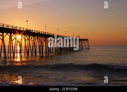 Early morning sunrise in September, at the Kure Beach fishing pier in Kure Beach, NC Stock Photo