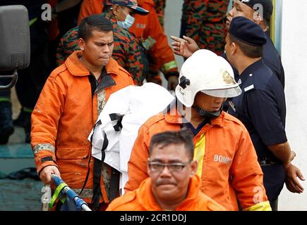 Firefighters leave religious school Darul Quran Ittifaqiyah after a fire broke out in Kuala Lumpur, Malaysia September 14, 2017. REUTERS/Lai Seng Sin