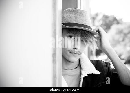 Black and white alternative young boy teenager portrait looking on camera in urban concept lifestyle - generazion z concept male with trendy look