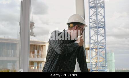 The worker in white hard hat was tired from work with contructio Stock Photo