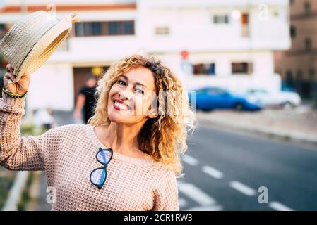 Cheerful adult caucasian people happy woman portrait with city urban background - joyful people in outdoor leisure activity during real lifestyle day