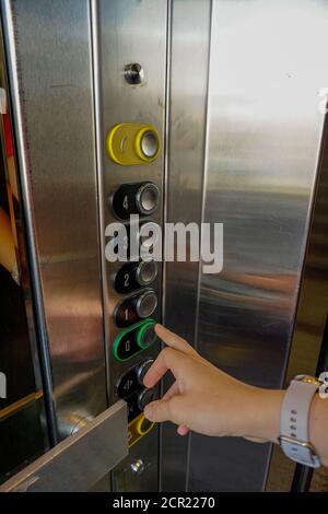 Woman hand on the elevator button close up view Stock Photo