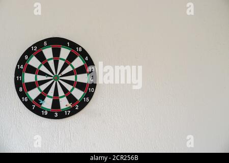 Dart game with the arrow on the center target close up view Stock Photo